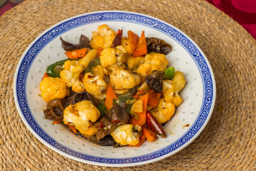 Spicy asian dish with peppers, vegetables and mushrooms