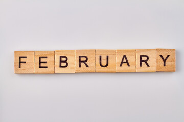 February word written on wood blocks. Isolated on white background.