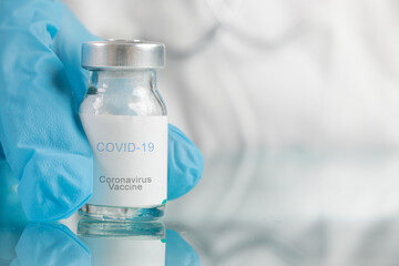 Scientist or medical worker holds Corona virus vaccine bottle.Vaccination, immunization, treatment to cure Covid 19 infection. Healthcare And Medical concept.