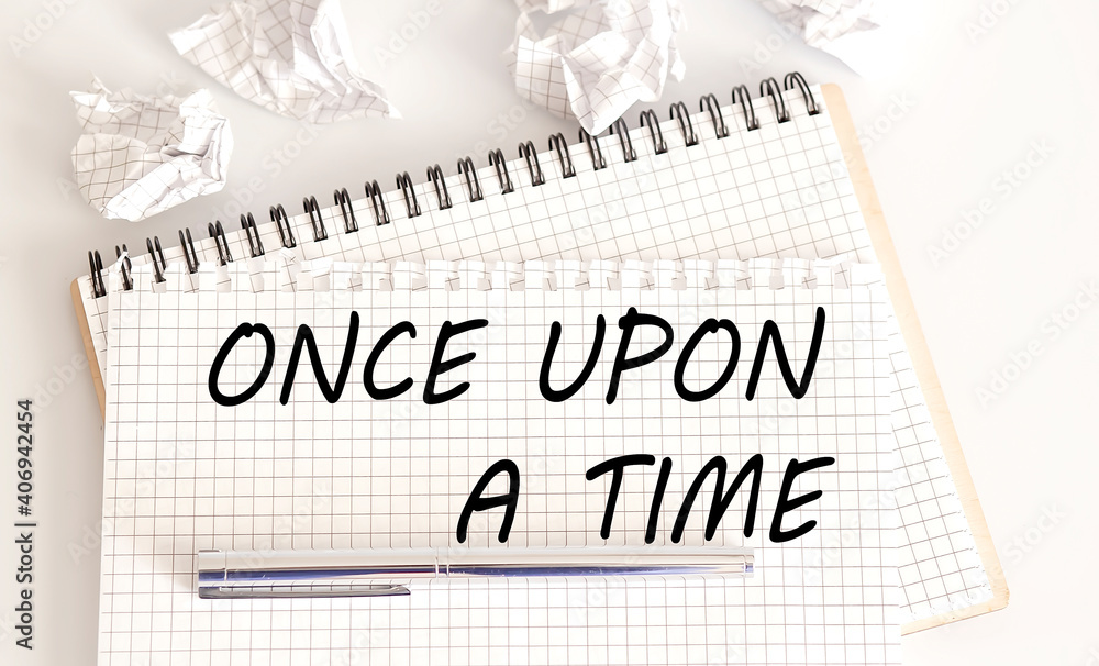 Poster text on notepad once upon a time on white background. business concept