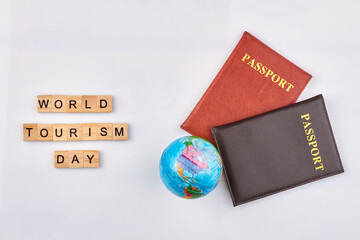 World day of tourism. Red and black passports with globe on white background.