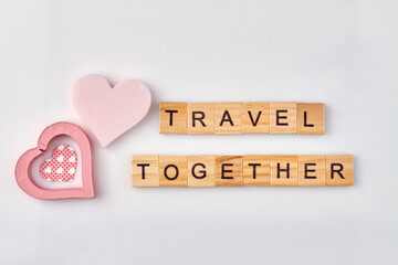 Travel together made with wooden alphabet cubes. Romantic journey concept on white background.