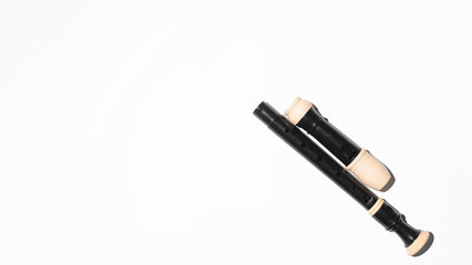 Disassembled musical flute on a white background, copy space. Top view