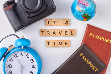 Essential things for travel. Camera and globe with passports and clock on white background.