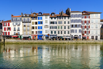 Naklejka premium City of Bayonne in France with typical houses and reflection on the Adur River 