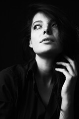 Obraz premium Emotional Sensual black and white portrait of a beautiful girl on a dark background