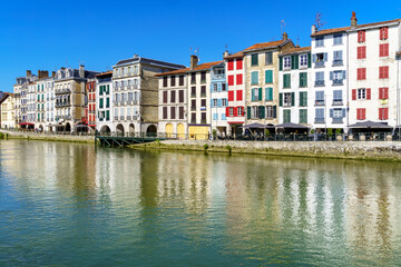 Fototapeta premium City of Bayonne in France with typical houses and reflection on the Adur River 