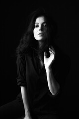 Naklejka premium Emotional Sensual black and white portrait of a beautiful girl on a dark background