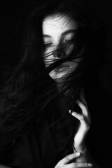 Emotional Sensual black and white portrait of a beautiful girl on a dark background