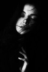 Emotional Sensual black and white portrait of a beautiful girl on a dark background
