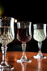 Different kinds of drinks in vintage cocktail glasses in a bar