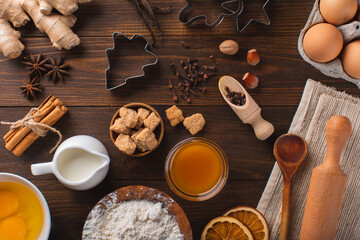 Delicious and healthy ingredients for Christmas baking on a wooden table, top-down view. Christmas baking background.