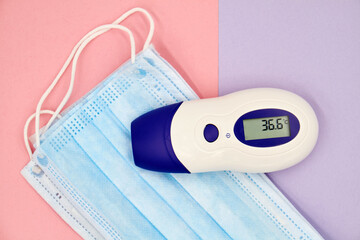 A non-contact infrared thermometer on the protective medical masks.