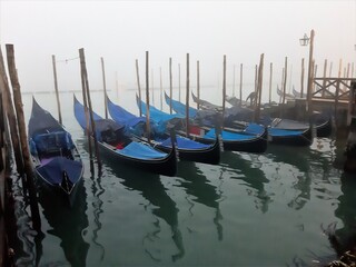 Fototapeta na wymiar Venice, Italy, January 27, 2020 evocative image of gondolas moored along a pier 