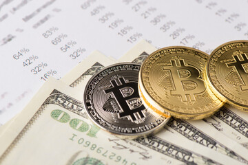 Close up view photo of golden and silver bitcoin and 100 american dollars pile