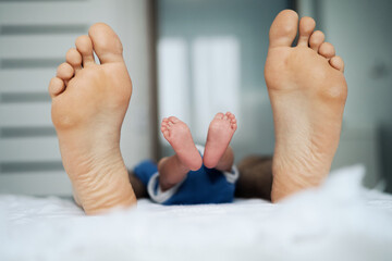 Father and baby's feet. High quality photo