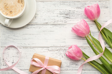 Top above overhead view photo of fresh beverage three pastel color tulips and kraft wrapped box on wooden vintage table
