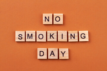 Smoking is unhealthy habit. Fighting a bad habit. Wooden blocks with letters isolated on orange background.