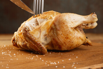 Whole Roasted Chicken on a wooden board, shallow depth of field