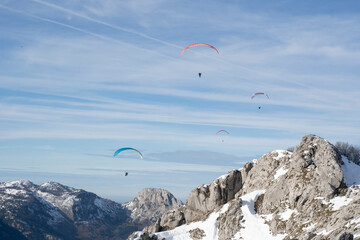 paragliders flying over the mountains 