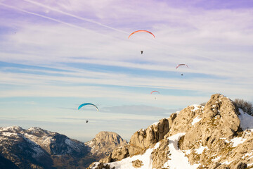 paragliders flying over the mountains 