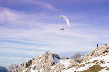 paragliders flying over the mountains 