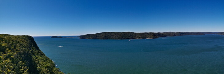 Beautiful panoramic view of a deep blue sea, small Lion island, West Head and Barrenjoey Lighthouse, Warrah Lookout, Brisbane Water National Park, New South Wales, Australia
