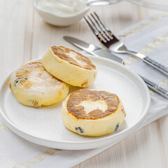 still life with cottage cheese pancakes with sour cream on white table