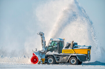 Snow removal vehicle in the airport. Snow blower. Cleaning airport from snow. Cleaning runway from snow.