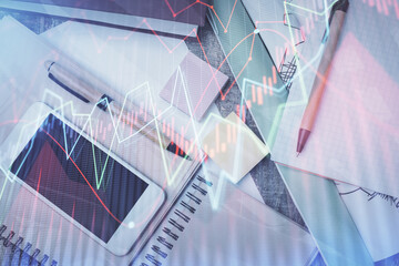 Multi exposure of forex graph hologram over desktop with phone. Top view. Mobile trade platform concept.