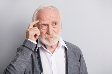 Portrait of old white hair think man look empty space finger forehead wear dark sweater isolated on grey background