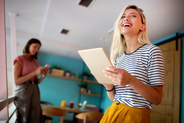 Portrait of pretty student or businesswoman in smart casual using digital tablet - Powered by Adobe