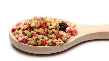 Red fruits cereal mix with wooden spoon, fruity and crunchy muesli with dried raspberry, strawberry, cherry chunks isolated on white background 