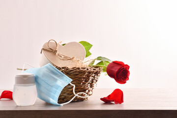 Gift and rose on basket with masks and gel isolated