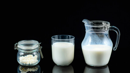 Homemade Kefir. Kefir Grains and Kefir in a Jug on a Black Background