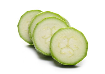 Chopped zucchini slices isolated on white background