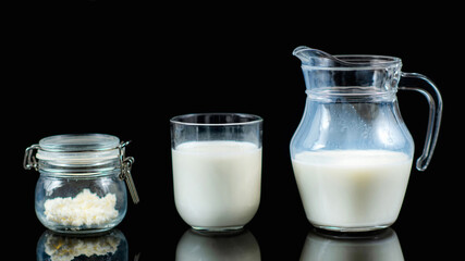 Homemade Kefir. Kefir Grains and Kefir in a Jug on a Black Background