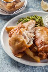 Fish in beer batter and chips with green pea and tartar sauce