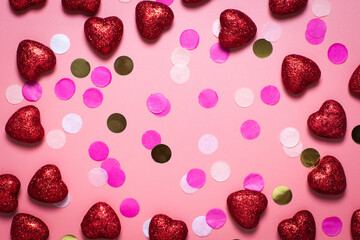 frame. blank card for valentine's day. on a pink background confetti and red hearts. funny congratulations. Flat lay, top view. red shiny hearts