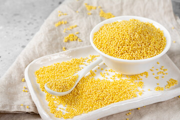 Millet. Millet in a white bowl on a light gray kitchen table