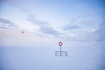 
no entry or transit, on a snow-covered road, over one meter of snow. desolation and silence in an abandoned landscape.