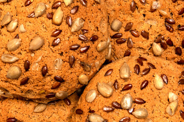 Fresh oatmeal cookies, gingerbread on a light background. Oatmeal gingerbreads sprinkled with sunflower and flax grains close up