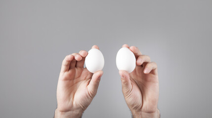 Fototapeta na wymiar Male hands holding white chicken eggs.