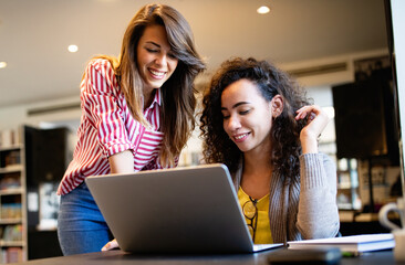 Group of college students studying in the school library