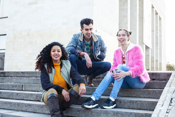 Fototapeta premium cute group of teenages at the building of university with books huggings, diversity nations real students lifestyle