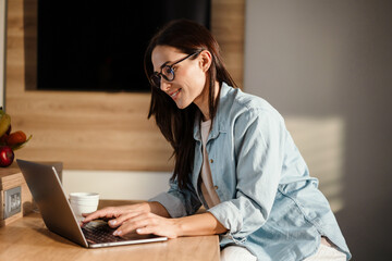 Attractive young smart woman working on laptop