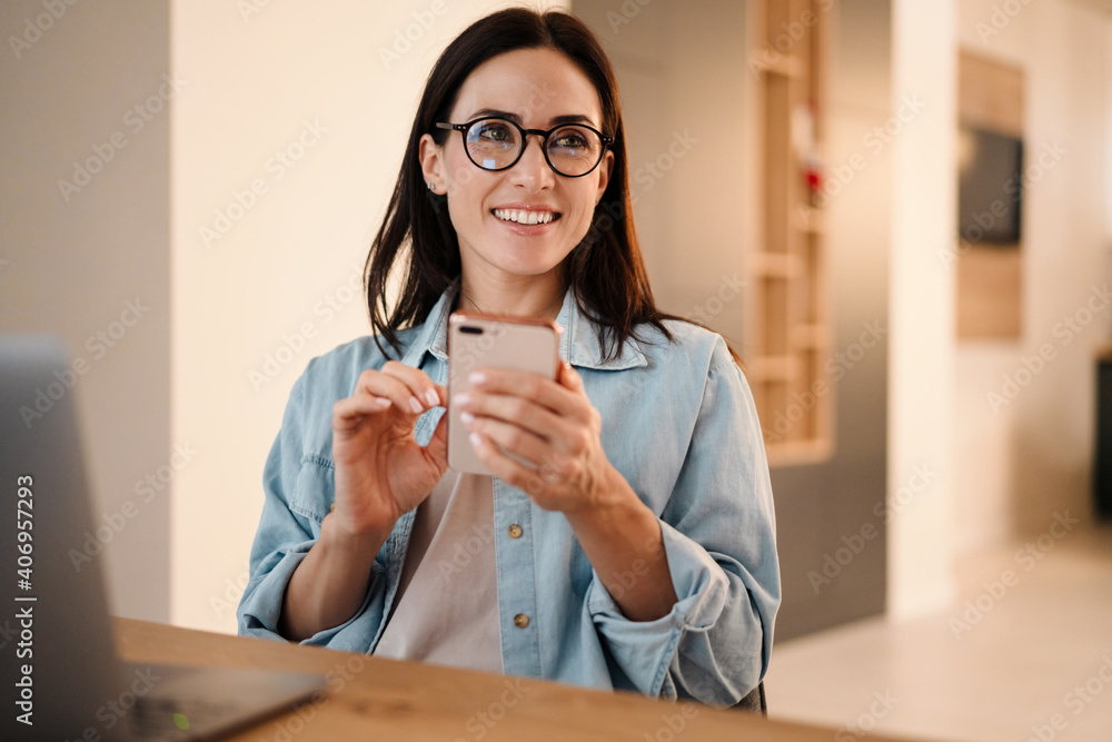 Wall mural beautiful woman using mobile phone and laptop computer