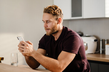 Handsome young man using mobile phone