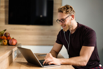 Young man working remotely and heaving a meeting