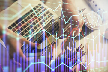 Double exposure of businesswoman hands typing on computer and financial graph hologram drawing. Stock market analysis concept.